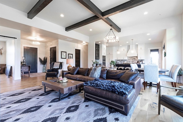 living room with beam ceiling, light wood-type flooring, and an inviting chandelier