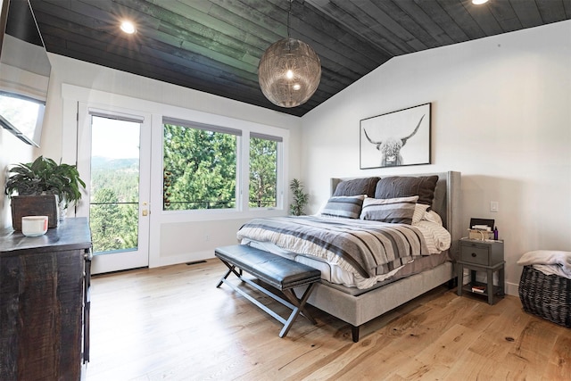 bedroom featuring light hardwood / wood-style floors, vaulted ceiling, and wooden ceiling