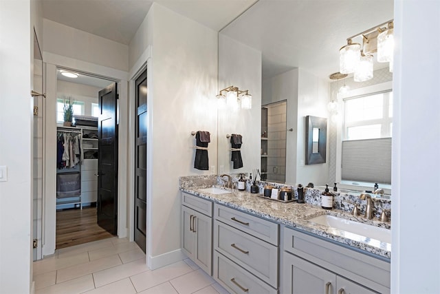 bathroom featuring walk in shower, vanity, tile patterned floors, and plenty of natural light