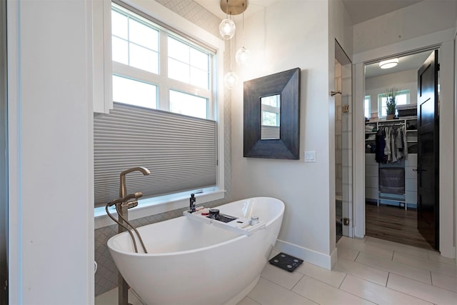 bathroom with tile patterned flooring and separate shower and tub