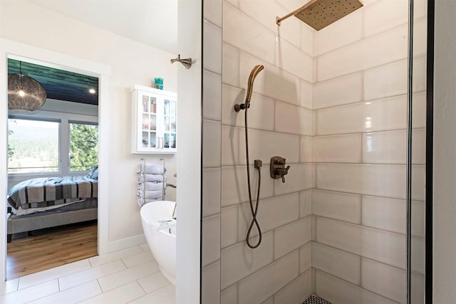 bathroom featuring tiled shower and tile patterned floors