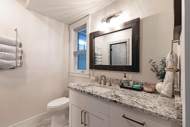 bathroom with tile patterned flooring, vanity, and toilet