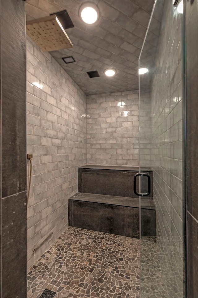 bathroom featuring a shower with shower door