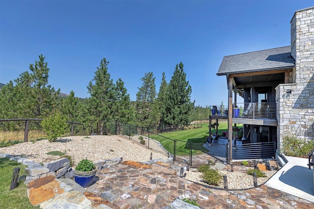 view of yard with a patio and a balcony