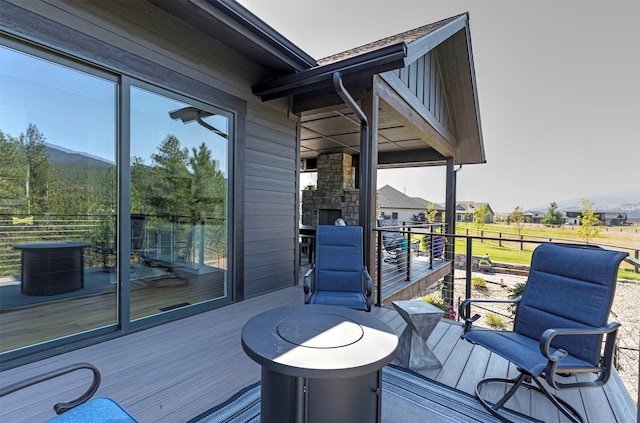 deck featuring an outdoor stone fireplace