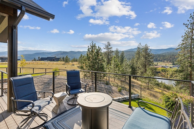 deck featuring a mountain view and a rural view