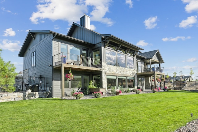 rear view of house featuring a yard