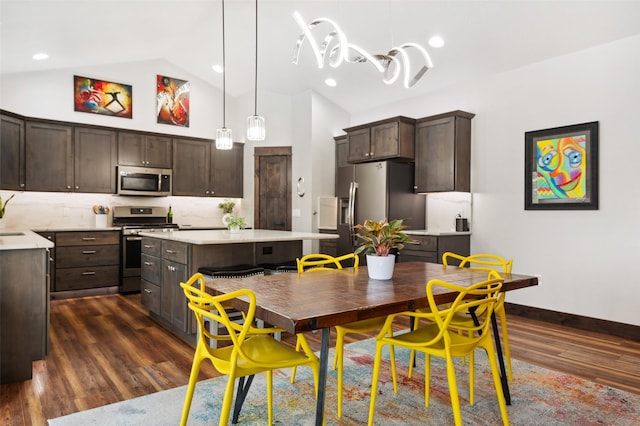 kitchen with dark hardwood / wood-style flooring, dark brown cabinetry, stainless steel appliances, a center island, and hanging light fixtures