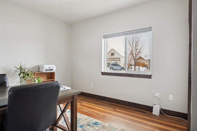 home office with hardwood / wood-style floors