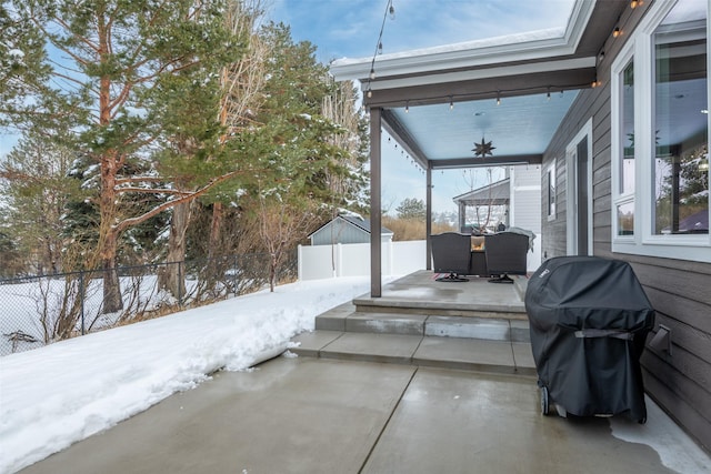 snow covered patio with grilling area