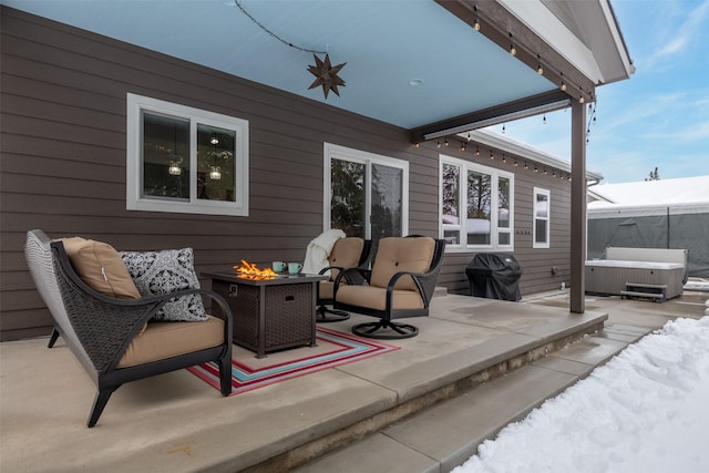 view of patio featuring a grill, a hot tub, and a fire pit