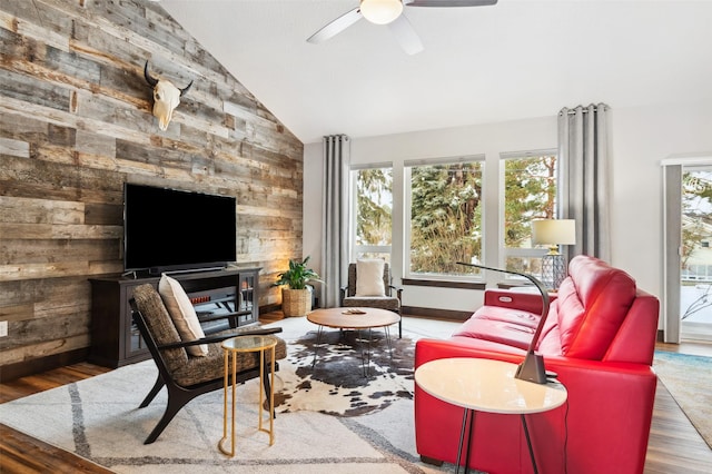 living room featuring ceiling fan, hardwood / wood-style floors, and lofted ceiling