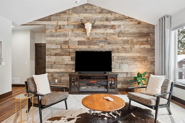 living room with hardwood / wood-style floors and lofted ceiling