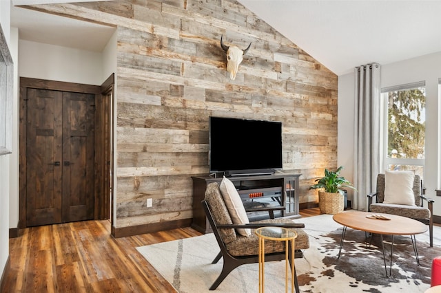 living area with wood-type flooring and lofted ceiling