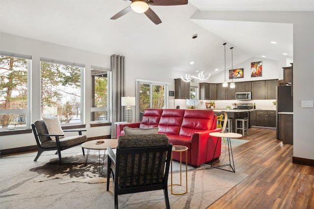 living room with dark hardwood / wood-style flooring, vaulted ceiling, and ceiling fan