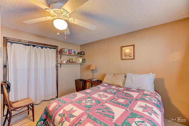 bedroom featuring carpet flooring, a textured ceiling, and ceiling fan