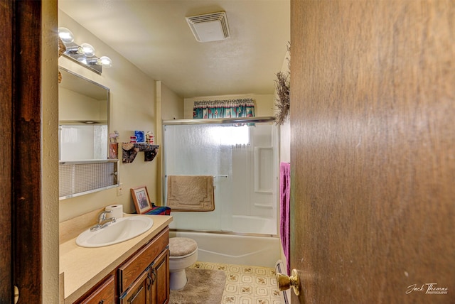 full bathroom with vanity, combined bath / shower with glass door, and toilet