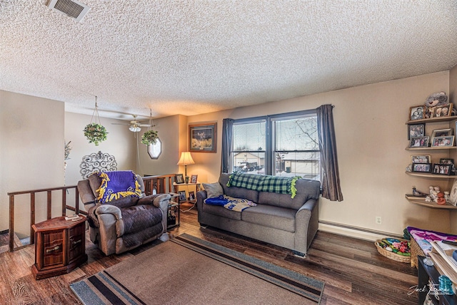 living room with ceiling fan, wood-type flooring, a textured ceiling, and a baseboard heating unit