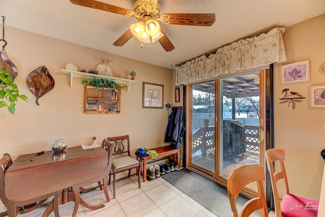 dining room featuring ceiling fan and a textured ceiling