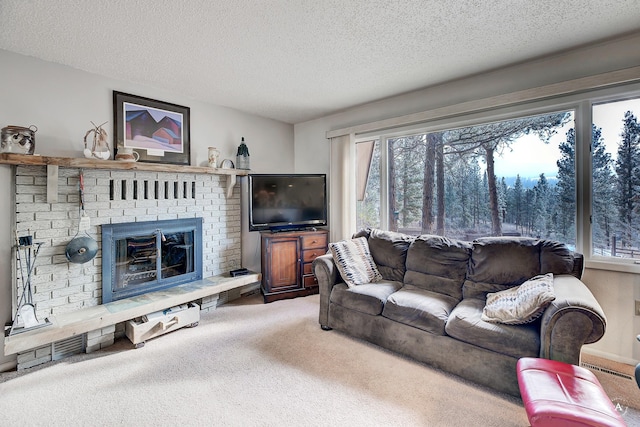 living room with a brick fireplace, a textured ceiling, and carpet flooring