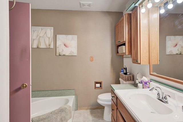 bathroom featuring a washtub, tile patterned flooring, vanity, and toilet