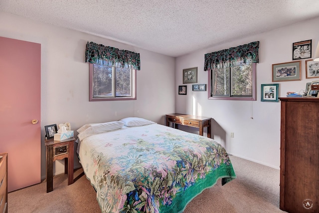 carpeted bedroom featuring a textured ceiling