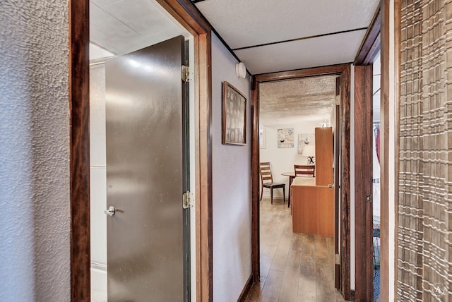 corridor with wood-type flooring