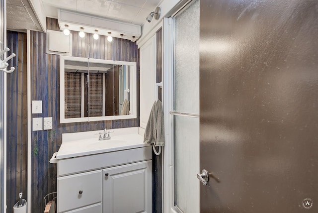 bathroom with vanity and wood walls