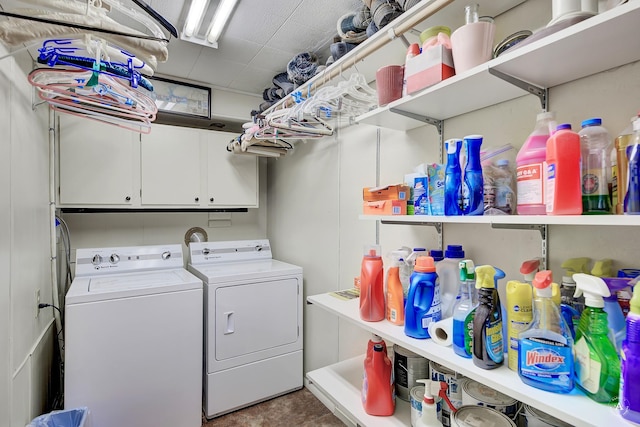 washroom with cabinets and washer and clothes dryer