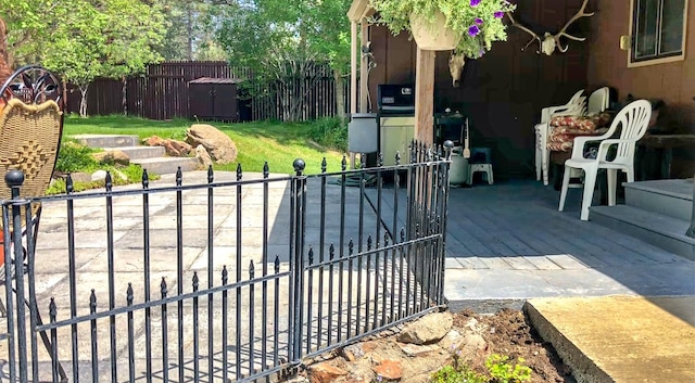 view of gate with a patio