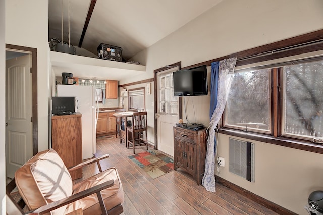 interior space featuring white fridge and lofted ceiling