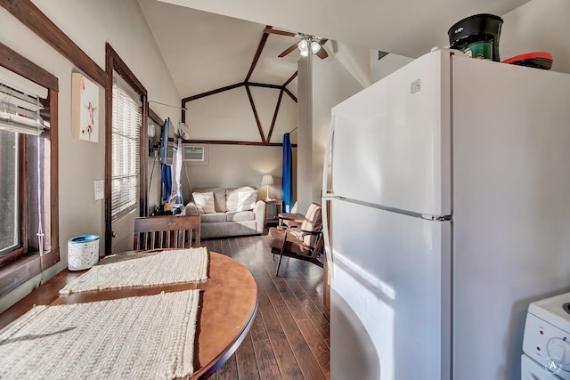 kitchen with white refrigerator, vaulted ceiling, ceiling fan, stove, and dark hardwood / wood-style flooring