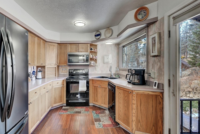 kitchen featuring black appliances, dark hardwood / wood-style flooring, a textured ceiling, and sink