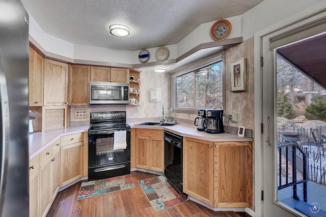 kitchen with sink, dark hardwood / wood-style flooring, a textured ceiling, and black appliances