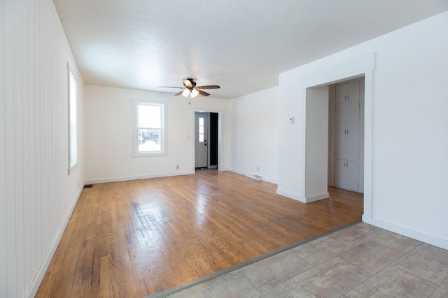 unfurnished room featuring ceiling fan and light hardwood / wood-style floors