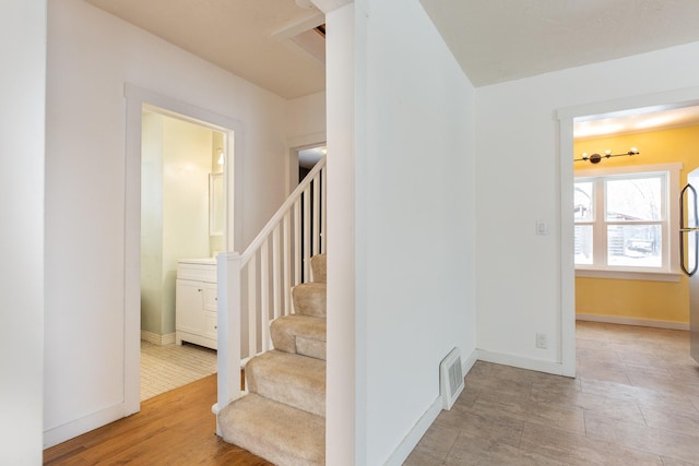 stairway featuring hardwood / wood-style flooring