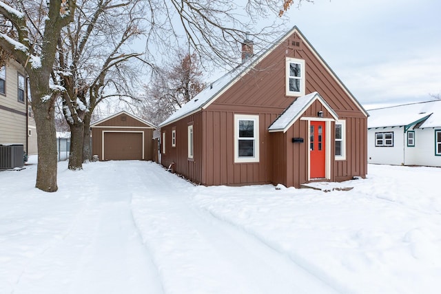 view of front of house featuring an outbuilding, central AC, and a garage