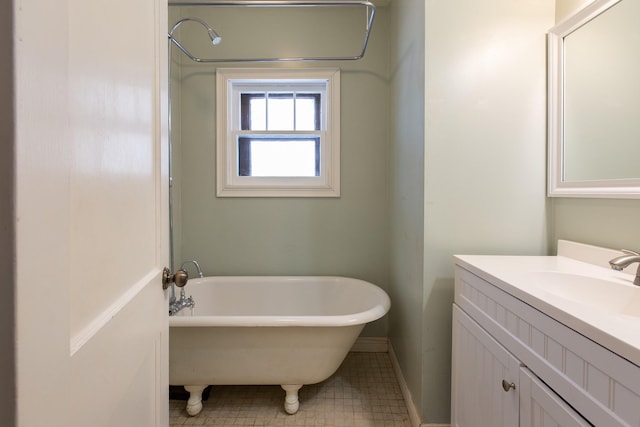 bathroom with vanity and a bath