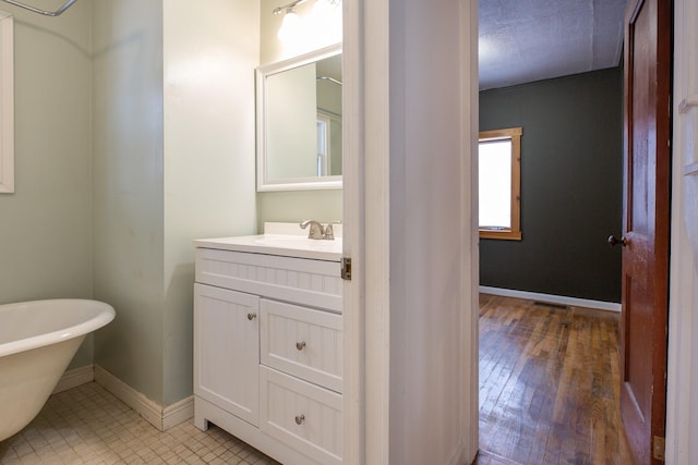 bathroom featuring vanity and a bath