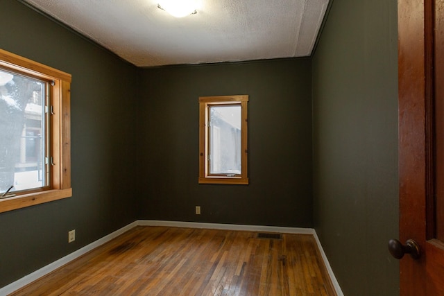 empty room featuring hardwood / wood-style floors and a textured ceiling