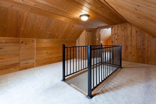 bonus room featuring wood walls, lofted ceiling, carpet floors, and wooden ceiling