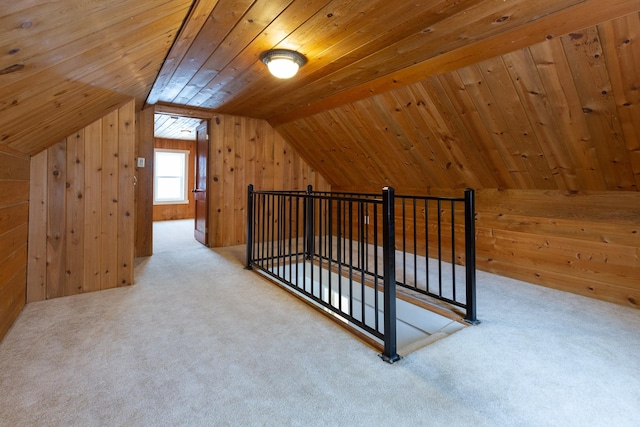 additional living space with wooden walls, carpet, wood ceiling, and vaulted ceiling