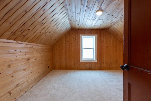 additional living space featuring wooden walls, light colored carpet, wooden ceiling, and vaulted ceiling