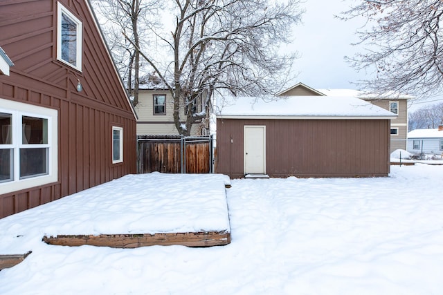 yard layered in snow featuring an outdoor structure