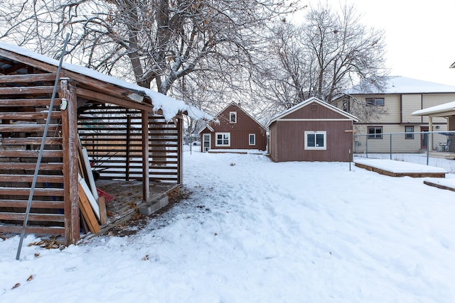 snowy yard featuring an outdoor structure