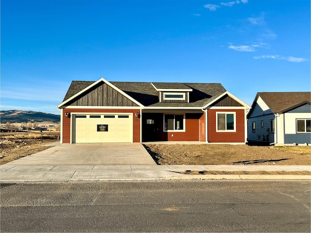 view of front facade featuring a mountain view and a garage