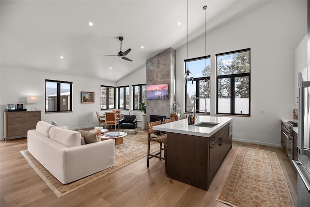 124 W 2nd St Unit B, Whitefish, MT 59937 - living area with high vaulted ceiling, recessed lighting, light wood-style floors, a ceiling fan, and baseboards