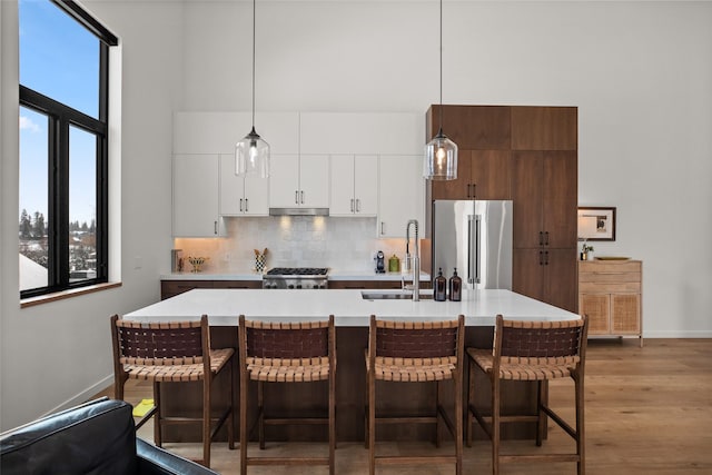 124 W 2nd St Unit B, Whitefish, MT 59937 - kitchen featuring high quality fridge, a sink, light countertops, baseboards, and a towering ceiling