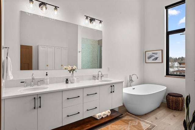 124 W 2nd St Unit B, Whitefish, MT 59937 - full bath featuring wood finished floors, a soaking tub, and double vanity