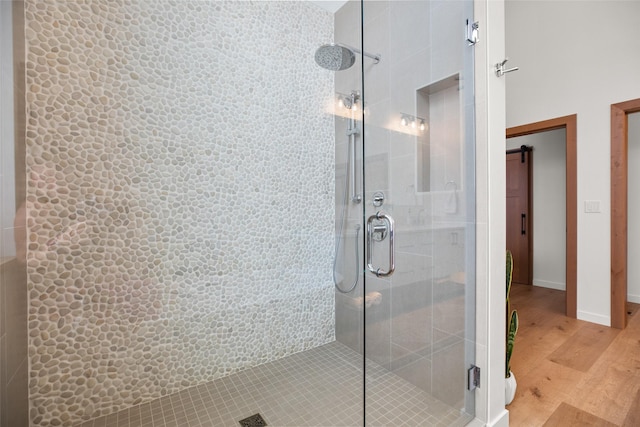 124 W 2nd St Unit B, Whitefish, MT 59937 - bathroom featuring wood finished floors, a stall shower, and baseboards